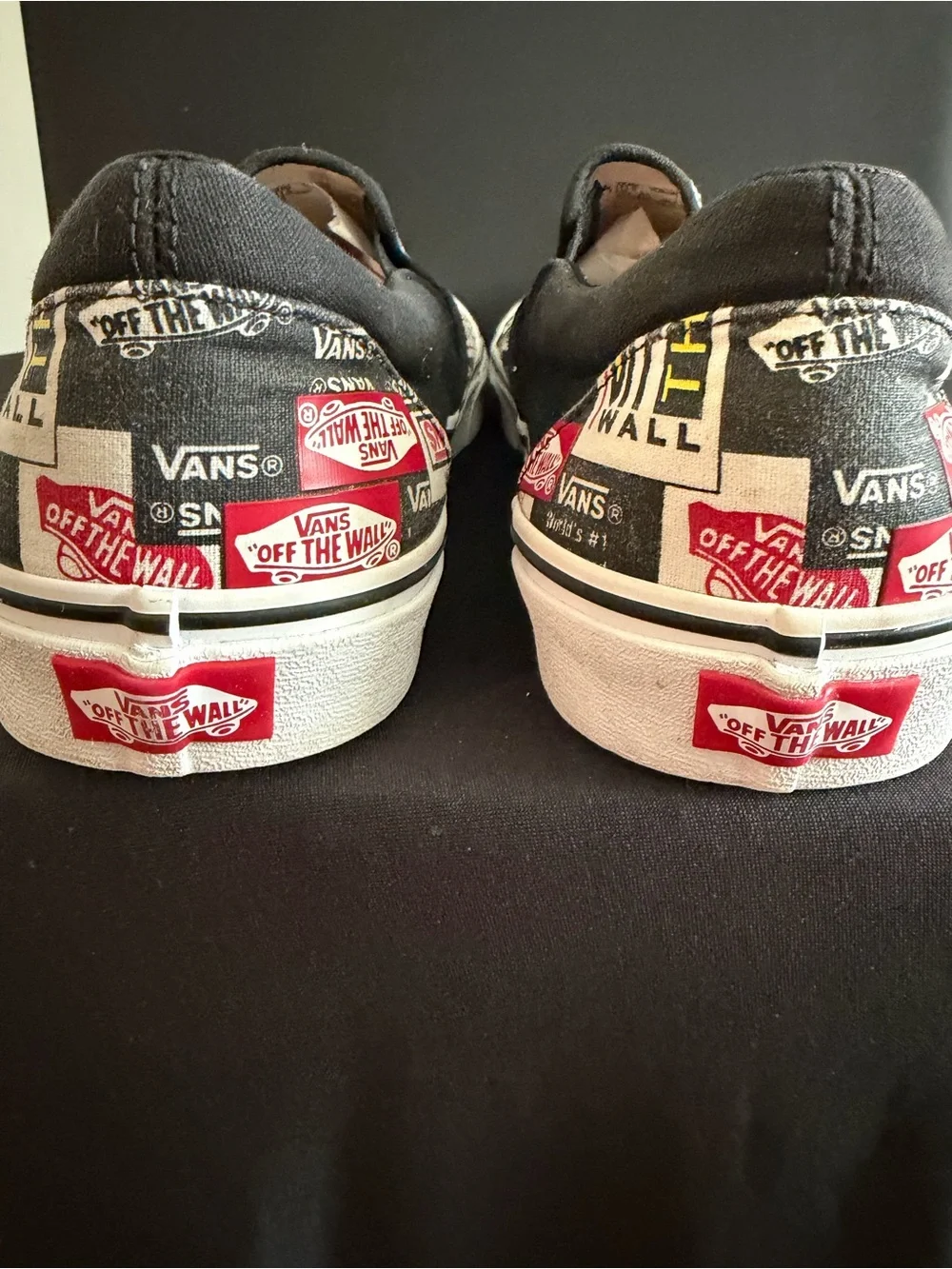 Vans Slip-On Sneakers in Black, White & Red Logo Print